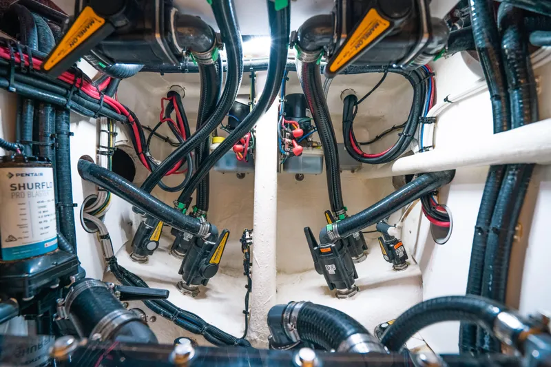 Slide: The Image of Engine room of 2023 Contender 39 ST boat with complex wiring and plumbing systems. - 36