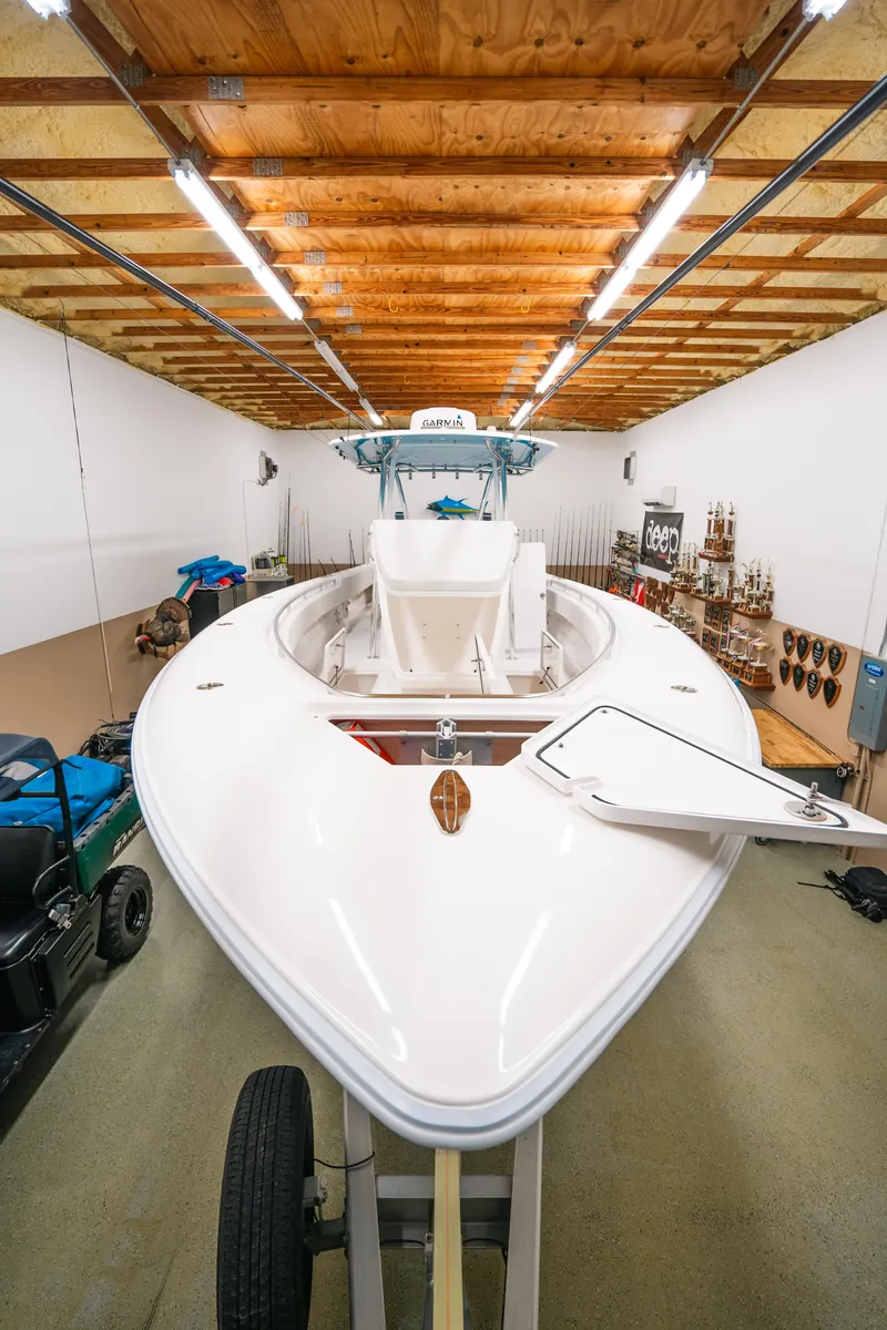 Slide: The Image of 2023 Contender 39 ST boat in a well-lit storage facility. - 5