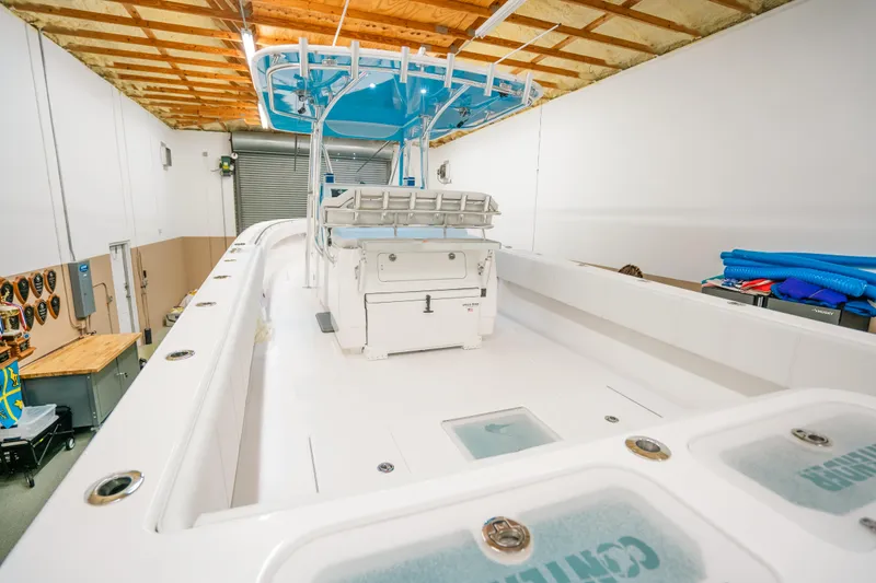 Slide: The Image of 2023 Contender 39 ST boat in storage, featuring spacious deck and modern design. - 8
