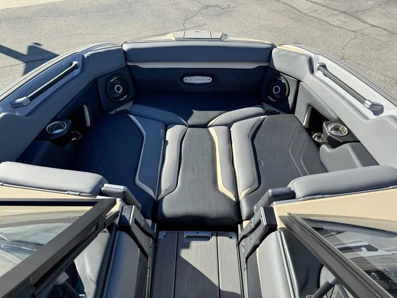 Slide: The Image of 2025 Supra SE boat interior with cushioned seating and built-in speakers. - 12