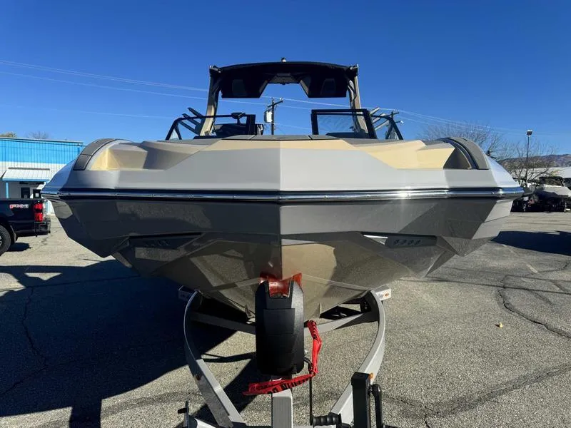 Slide: The Image of 2025 Supra SE boat on trailer, parked outdoors under clear blue sky. - 3