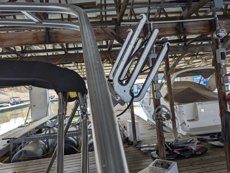 Slide: The Image of 2006 Sea Ray 240 Sundeck docked in a marina with equipment visible. - 10