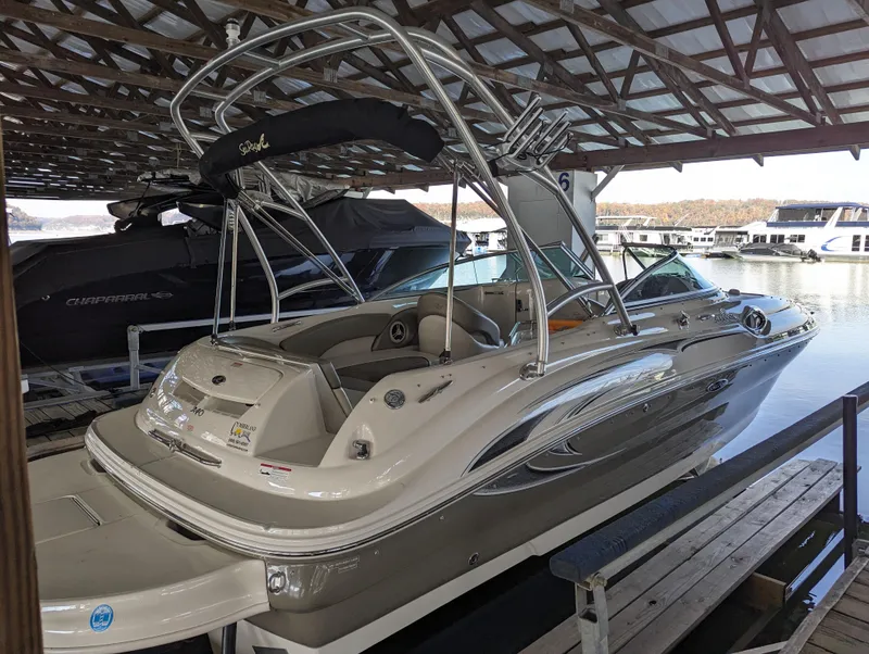 Slide: The Image of 2006 Sea Ray 240 Sundeck boat docked under a covered marina. - 11