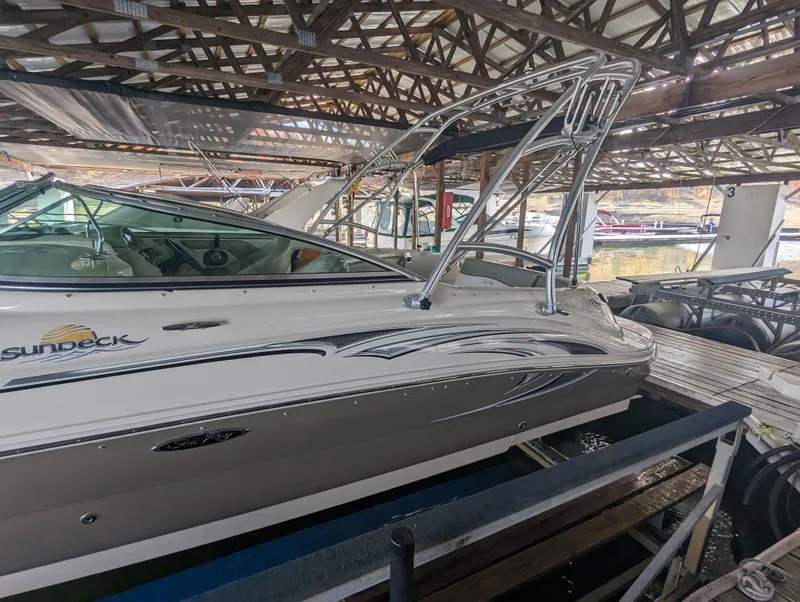 Slide: The Image of 2006 Sea Ray 240 Sundeck boat docked in a covered marina. - 14