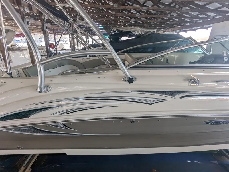 Slide: The Image of 2006 Sea Ray 240 Sundeck boat in covered storage, side view. - 16