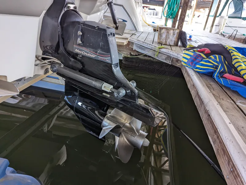 Slide: The Image of MerCruiser outdrive on 2006 Sea Ray 240 Sundeck, docked with life jackets nearby. - 18