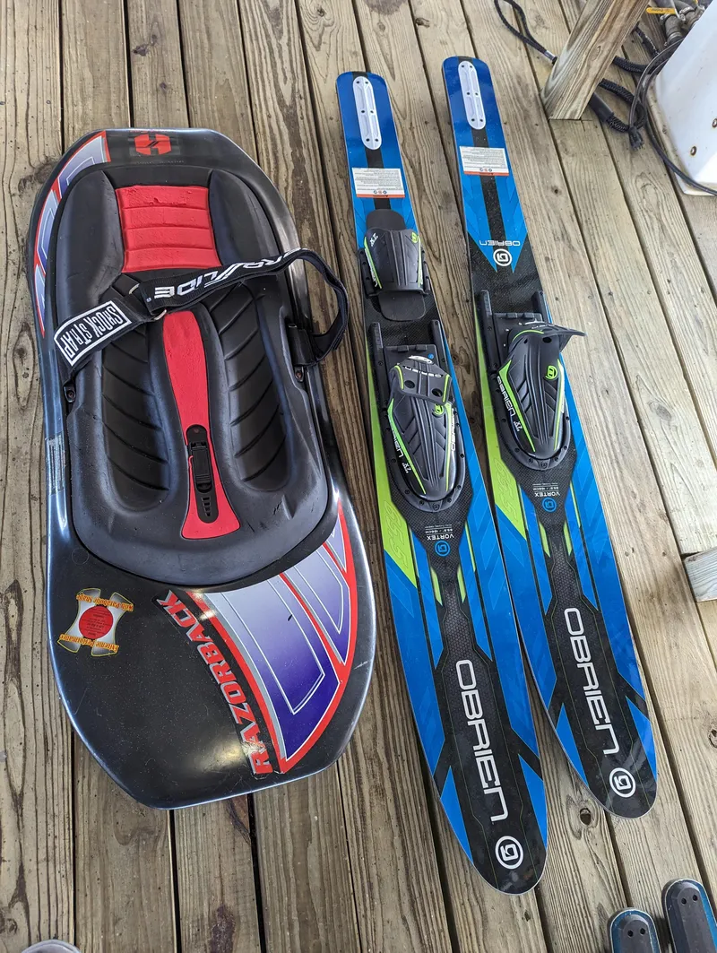 Slide: The Image of Kneeboard and water skis on wooden deck, Sea Ray 240 Sundeck 2006 accessories. - 22