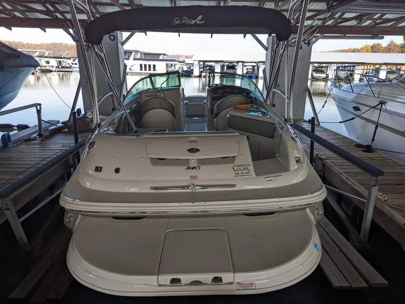 Slide: The Image of 2006 Sea Ray 240 Sundeck boat docked in a marina. - 24