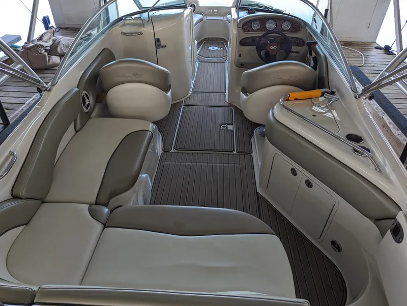 Slide: The Image of 2006 Sea Ray 240 Sundeck interior with spacious seating and modern dashboard. - 26