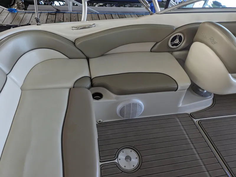Slide: The Image of 2006 Sea Ray 240 Sundeck interior seating with gray and white upholstery. - 27