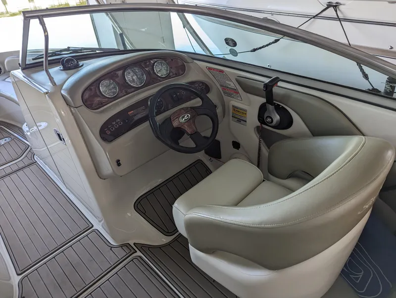 Slide: The Image of 2006 Sea Ray 240 Sundeck boat interior with steering wheel and dashboard. - 29