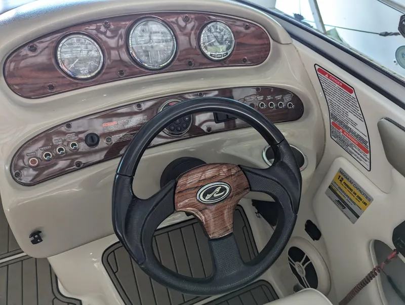 Slide: The Image of Steering wheel and dashboard of 2006 Sea Ray 240 Sundeck boat. - 38