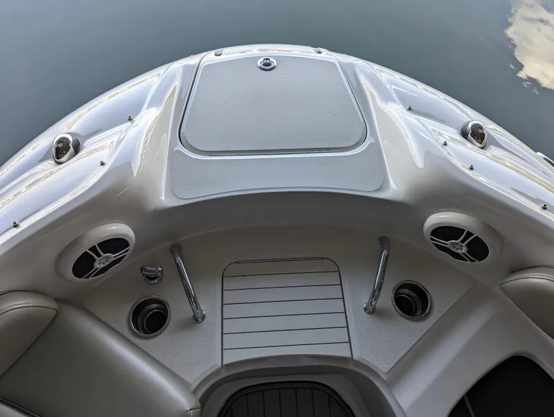 Slide: The Image of 2006 Sea Ray 240 Sundeck boat deck with speakers and cup holders. - 44