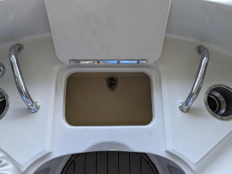 Slide: The Image of 2006 Sea Ray 240 Sundeck boat deck with storage compartment and stainless steel handles. - 45