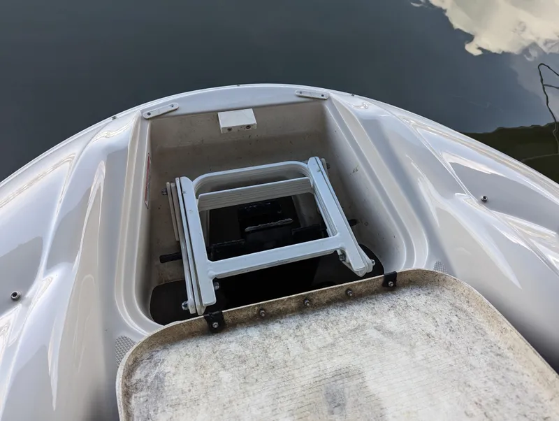 Slide: The Image of 2006 Sea Ray 240 Sundeck boat with a foldable ladder at the bow. - 46