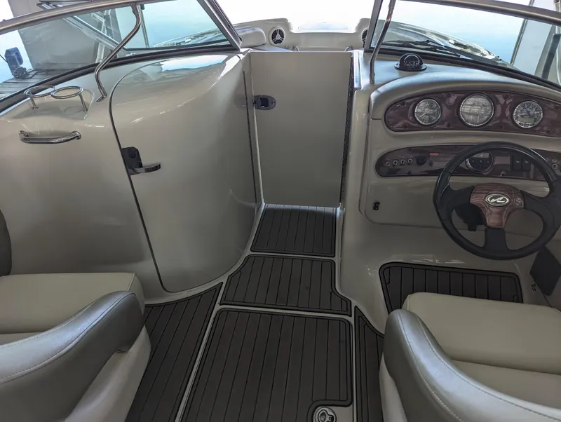Slide: The Image of 2006 Sea Ray 240 Sundeck interior with steering wheel and dashboard. - 49