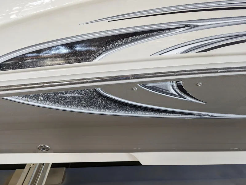 Slide: The Image of 2006 Sea Ray 240 Sundeck boat with sleek silver and black graphics. - 7