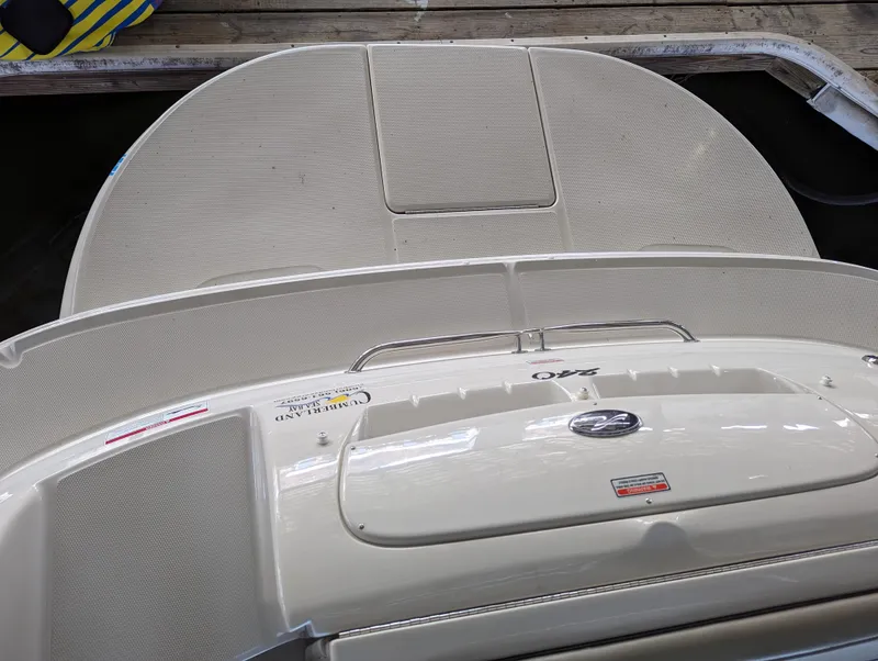 Slide: The Image of 2006 Sea Ray 240 Sundeck boat deck, featuring a sleek design and spacious layout. - 9