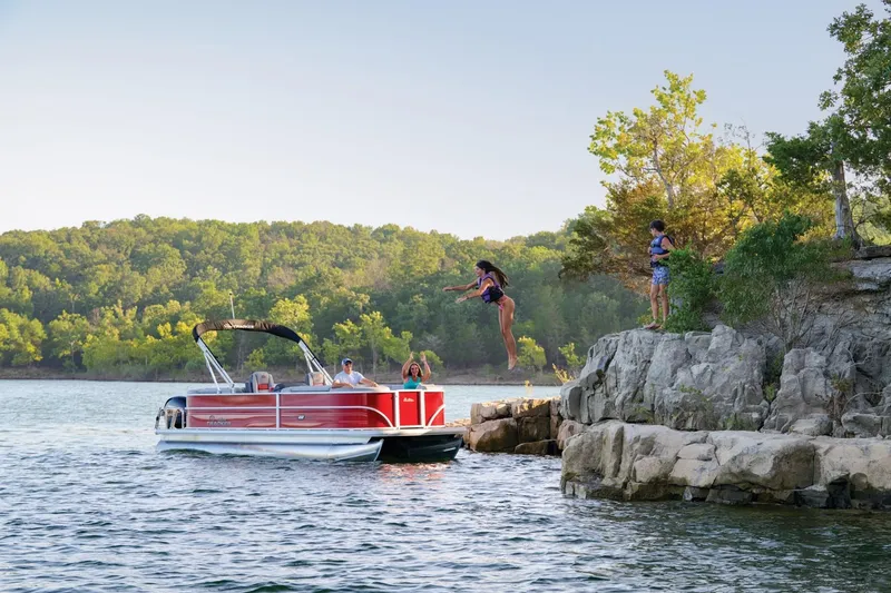 Slide: The Image of 2025 Sun Tracker Party Barge 22 DLX storage compartment with cushioned seating. - 11