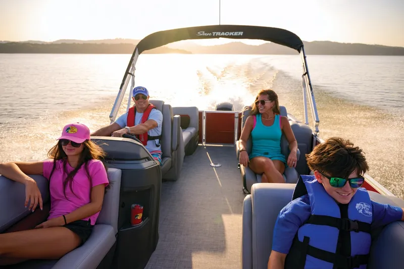 Slide: The Image of 2025 Sun Tracker Party Barge 22 DLX interior with beige seating and cup holder. - 14