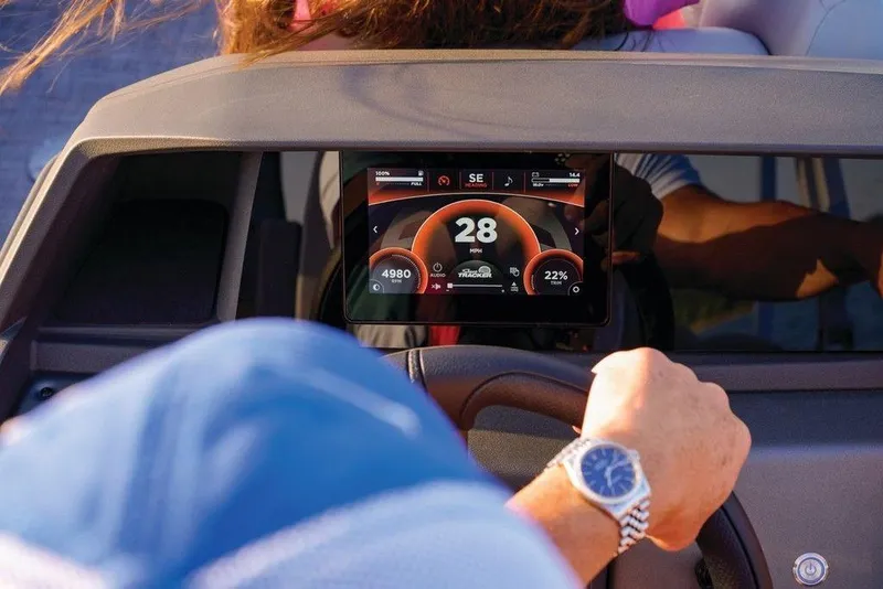 Slide: The Image of 2025 Sun Tracker Party Barge 22 DLX dashboard with digital speedometer display. - 29