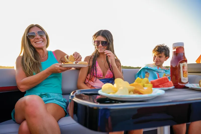 Slide: The Image of 2025 Sun Tracker Party Barge 22 DLX interior with cup holder and seating detail. - 5