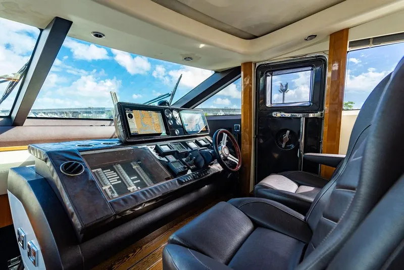 Slide: The Image of Luxurious 2010 Princess V78 yacht cockpit with modern navigation equipment and leather seating. - 25