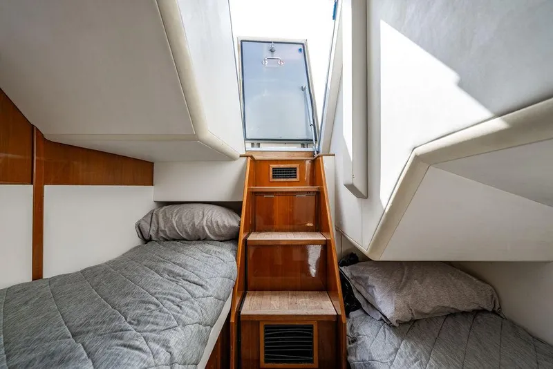Slide: The Image of Interior of 2010 Princess V78 yacht with twin beds and wooden stairs. - 44