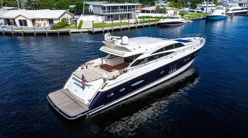 Slide: The Image of 2010 Princess V78 yacht cruising on a serene waterway near waterfront homes. - 9