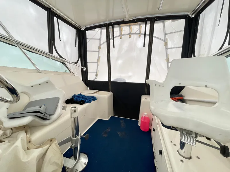 Slide: The Image of Interior of 1999 Henriques 28 Express boat with seating and helm. - 10
