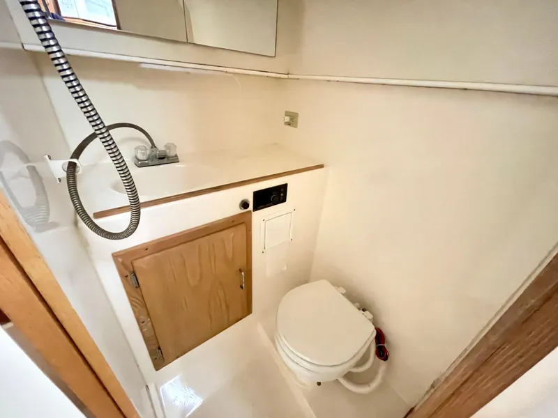 Slide: The Image of 1999 Henriques 28 Express boat bathroom with toilet and sink. - 17