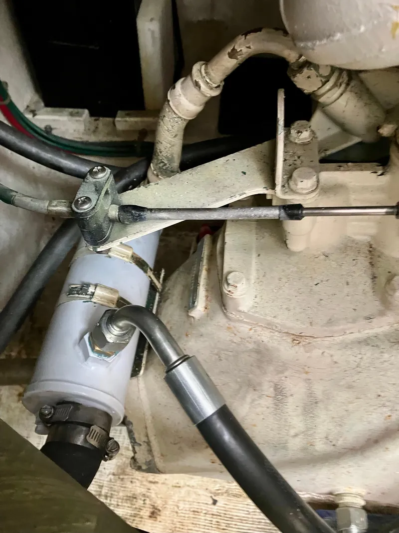 Slide: The Image of Engine components of a 1999 Henriques 28 Express boat, featuring hoses and connectors. - 21