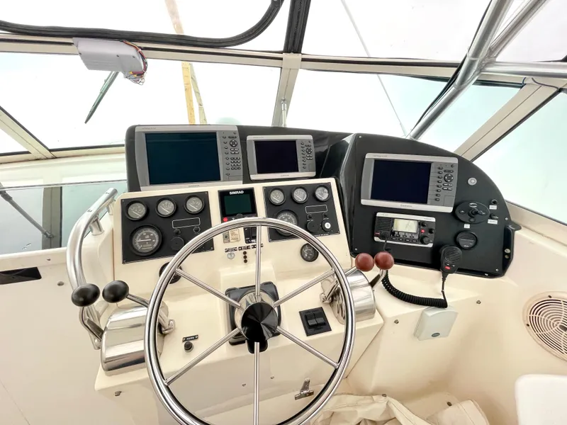 Slide: The Image of 1999 Henriques 28 Express boat helm with navigation instruments and steering wheel. - 6