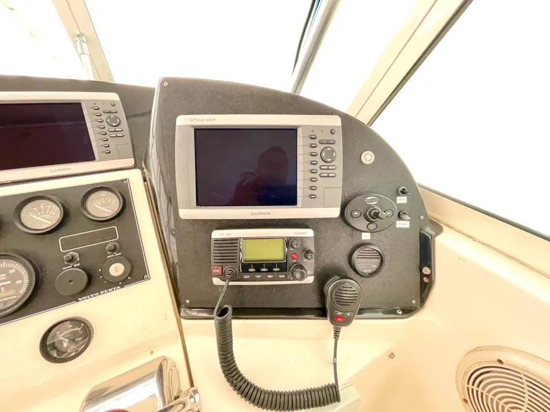 Slide: The Image of 1999 Henriques 28 Express boat dashboard with navigation and communication equipment. - 8