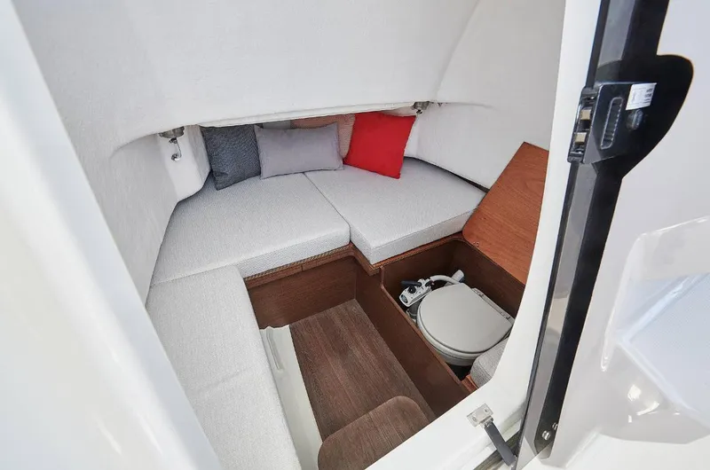 Slide: The Image of 2023 Jeanneau Leader 7.5CC S3 cabin interior with seating and compact toilet. - 13