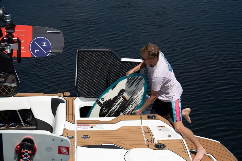 Slide: The Image of Person preparing to wakesurf on 2025 Ingenity GS22E boat. - 3