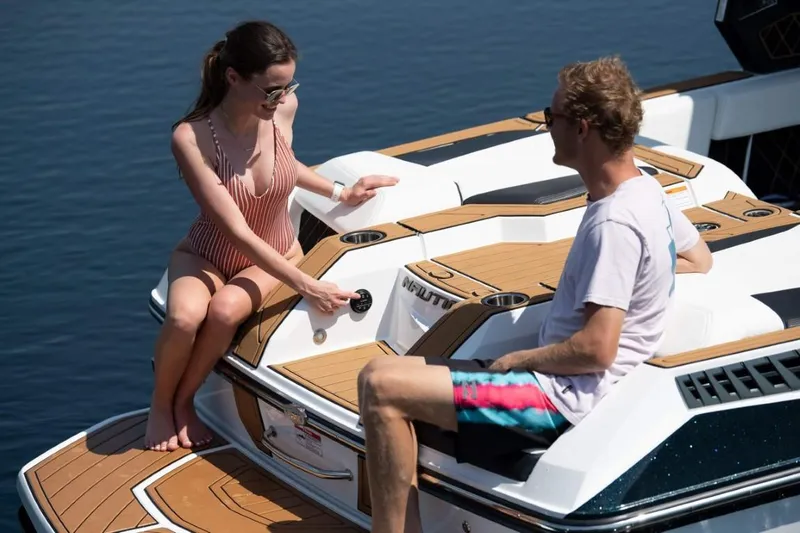 Slide: The Image of Two people relaxing on a 2025 Ingenity GS22E boat deck. - 4