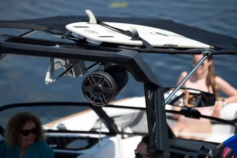 Slide: The Image of 2025 Ingenity GS22E boat with surfboard and speaker, people relaxing onboard. - 7