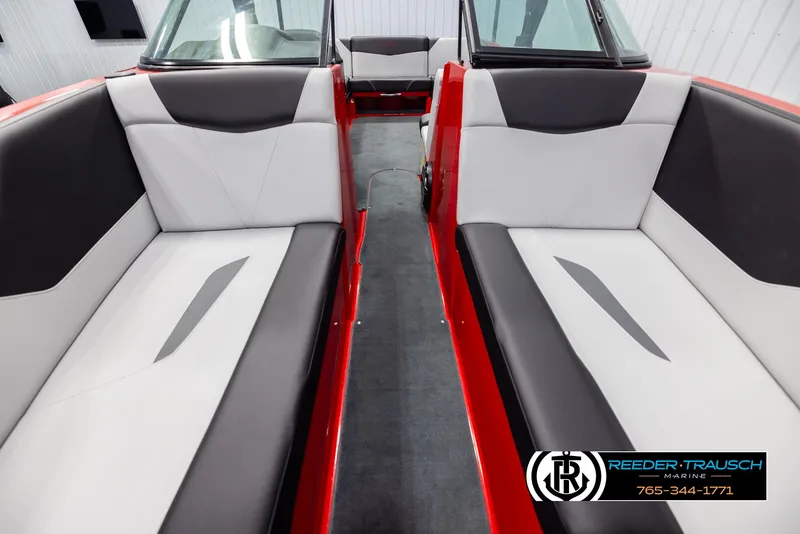 Slide: The Image of 2021 MasterCraft NXT24 boat interior with red accents and gray seating. - 16