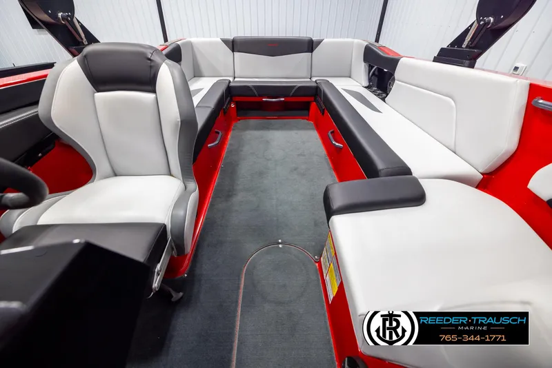 Slide: The Image of 2021 MasterCraft NXT24 boat interior with red and white seating, Reeder-Trausch Marine logo. - 17