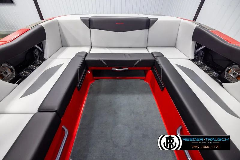 Slide: The Image of 2021 MasterCraft NXT24 boat interior with red and black seating. - 18