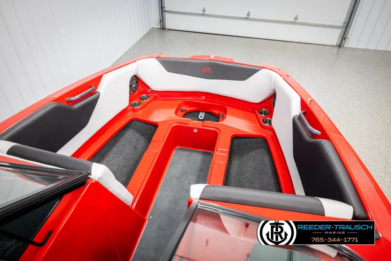 Slide: The Image of 2021 MasterCraft NXT24 boat interior with red and white seating, Reeder-Trausch Marine logo. - 20