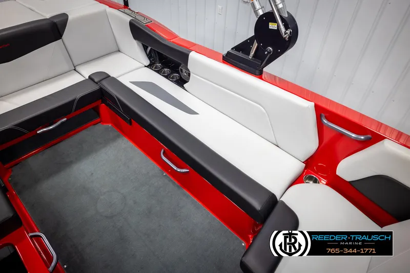 Slide: The Image of 2021 MasterCraft NXT24 boat interior with red and white seating, Reeder-Trausch Marine logo. - 23