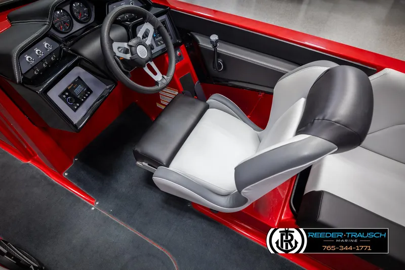 Slide: The Image of 2021 MasterCraft NXT24 boat interior with red accents and modern dashboard. - 25