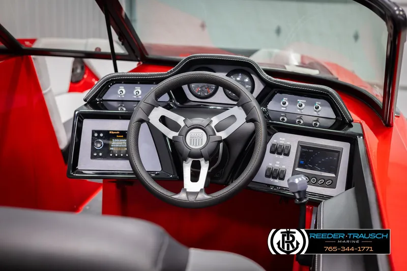 Slide: The Image of 2021 MasterCraft NXT24 boat dashboard with steering wheel and control panels. - 27