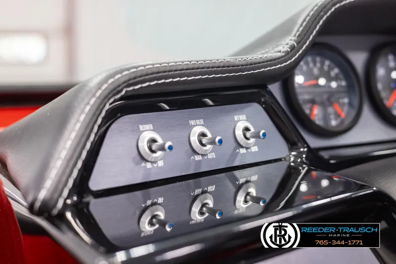 Slide: The Image of Close-up of 2021 MasterCraft NXT24 boat dashboard controls with switches and gauges. - 31