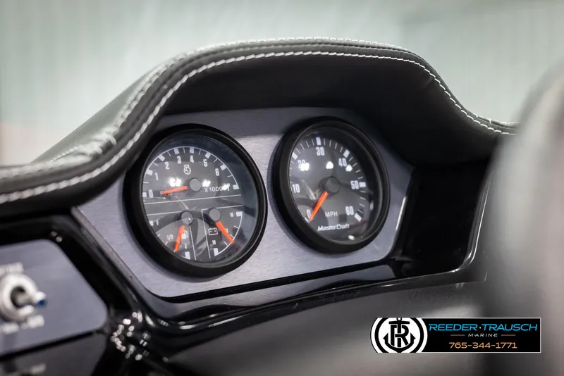 Slide: The Image of Dashboard of 2021 MasterCraft NXT24 boat with speedometer and tachometer gauges. - 32