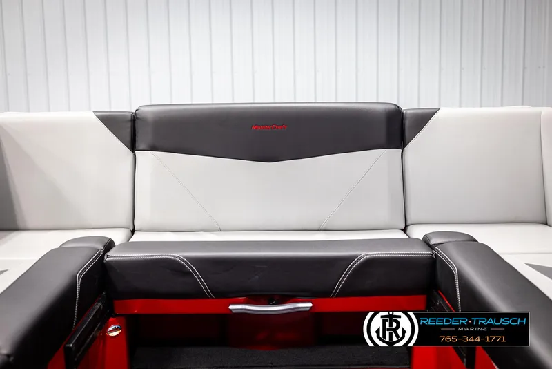 Slide: The Image of 2021 MasterCraft NXT24 boat interior with black and white seating, Reeder-Trausch Marine logo. - 38