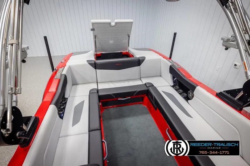 Slide: The Image of 2021 MasterCraft NXT24 boat interior with red and gray seating. - 47