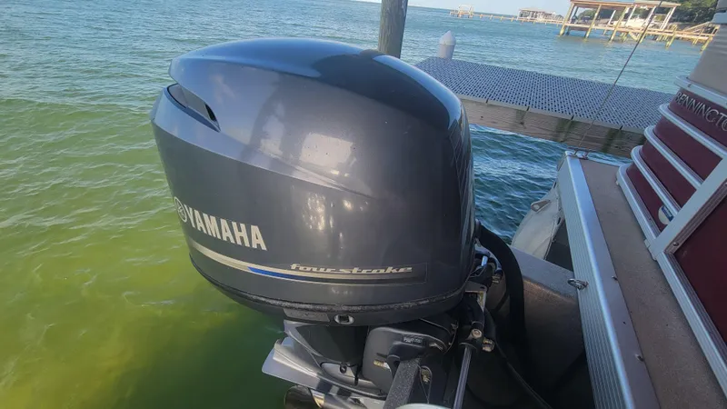 Slide: The Image of Yamaha outboard motor on 2012 Bennington 2274 GL pontoon boat by the water. - 1